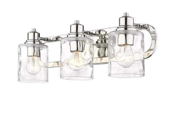 The Lumley 3-Light Bath Sconce combines timeless design with quality craftsmanship. Featuring hand-blown clear optic glass shades and polished nickel finish, this 22-inch fixture provides excellent task lighting for bathrooms. - alternate view