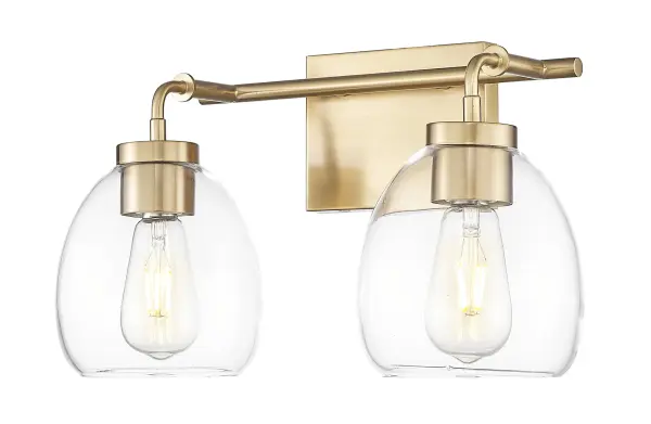 The Dawes 2-Light Wall Sconce combines brass and bronze finishes with clear glass for a sophisticated transitional look. Its 16-inch width and steel construction make it ideal for bathroom vanities and hallways.
