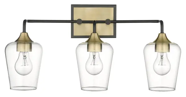 The Gladys 3-Light Wall Sconce combines matte black steel with antique brass accents and clear glass shades for a sophisticated industrial look. At 23 inches wide, it makes a bold statement while providing ample illumination.