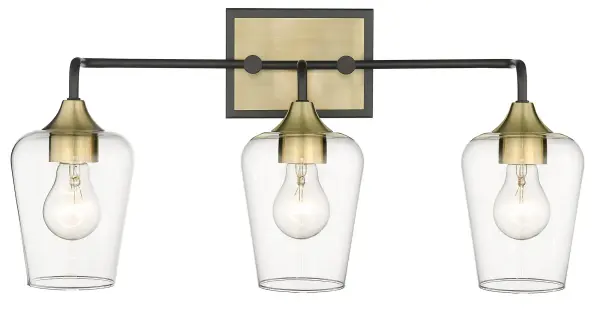 The Gladys 3-Light Wall Sconce combines matte black steel with antique brass accents and clear glass shades for a sophisticated industrial look. At 23 inches wide, it makes a bold statement while providing ample illumination. - alternate view