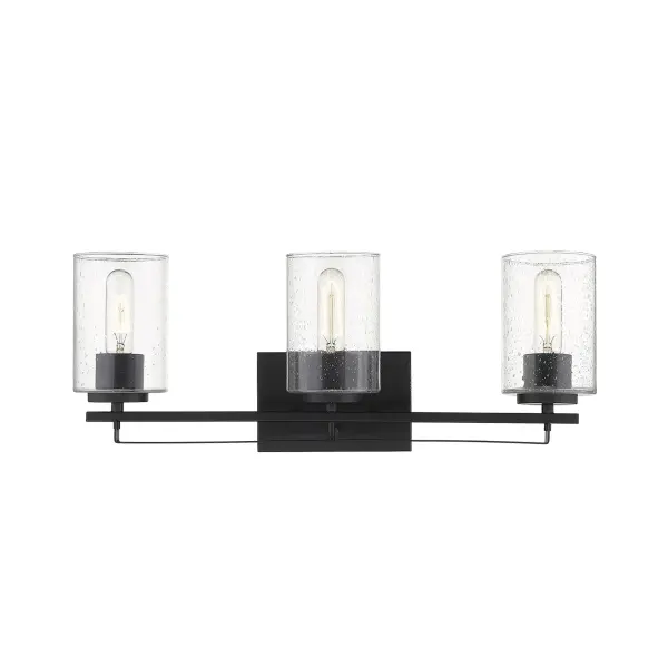 The Orella 3-Light Sconce combines industrial styling with practical vanity lighting. Three clear seeded glass cylindrical shades provide ample illumination while the matte black steel frame adds modern edge to bathrooms and bedrooms. - alternate view