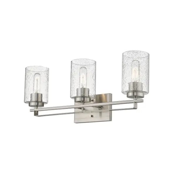 The Orella 3-Light Sconce combines timeless design with practical illumination, featuring clear seeded glass shades and a refined satin nickel finish. Its 24-inch width provides excellent coverage for medium to large vanities. - alternate view