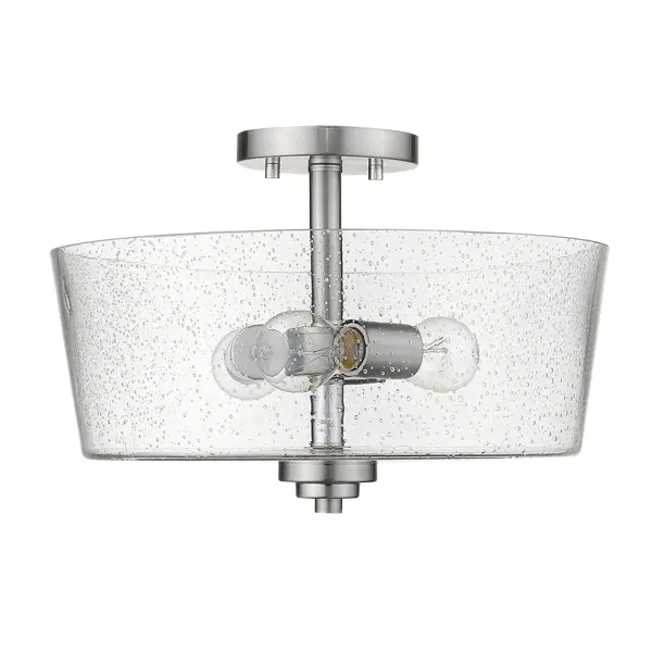 The Rowe semi-flush mount combines transitional styling with practical functionality. Its 15-inch width and seeded glass drum shade provide ambient lighting ideal for smaller spaces with standard ceiling heights.