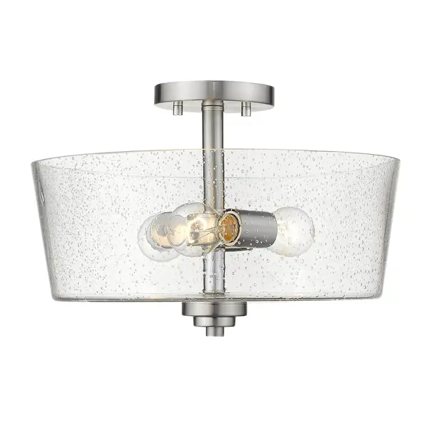 The Rowe semi-flush mount combines transitional styling with practical functionality. Its 15-inch width and seeded glass drum shade provide ambient lighting ideal for smaller spaces with standard ceiling heights. - alternate view