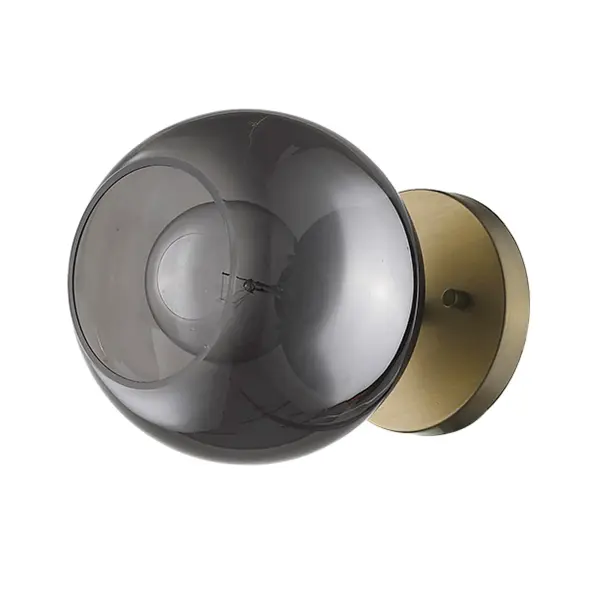 The Lunette sconce combines aged brass warmth with sophisticated smoked glass globes in a compact 7-inch profile. Perfect for modern bathrooms and hallways where space is limited but style matters.