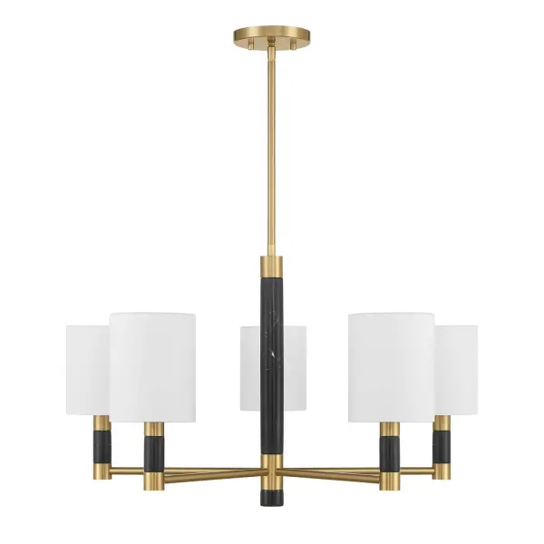 The Conrad chandelier combines classic design with luxurious materials. Black marble accents with unique veining patterns add natural beauty, while crisp white fabric shades soften the light. The Warm Brass finish brings warmth and sophistication to any space.