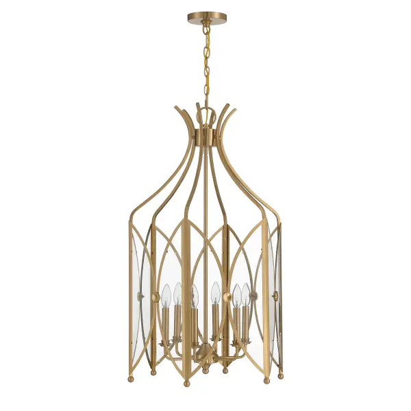 The Enclave pendant combines architectural drama with refined elegance through its distinctive curved glass panels that evoke organic leaf forms. The Noble Brass finish adds warmth and luxury, while the generous 21-inch width makes a bold statement in grand spaces. - alternate view