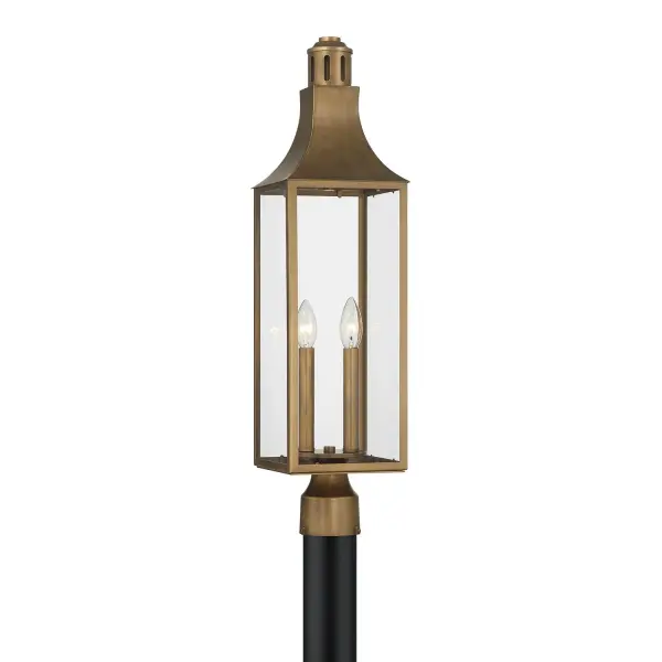 The Lancaster post lantern brings timeless elegance to outdoor spaces with its traditional architecture, graceful roof detailing, and warm Atlas Bronze finish. Clear glass panels maximize light output while wet-rated construction ensures durability.
