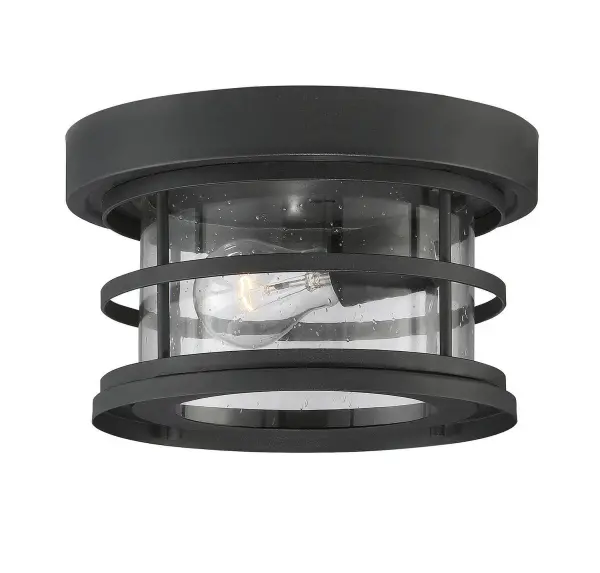 The Barrett flush mount combines industrial style with outdoor durability. Its protective grid frame and seeded glass create visual interest while the wet-rated construction ensures reliable performance in exposed locations.