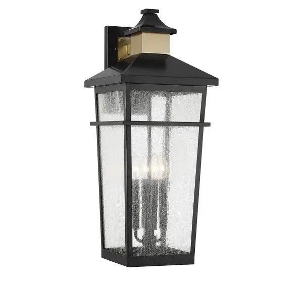 The Kingsley outdoor wall lantern combines coastal charm with contemporary style through its seedy glass panels and striking matte black and warm brass finish. At 28 inches tall, it makes a bold statement on exterior walls.
