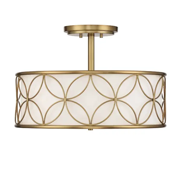 The Reid semi-flush mount combines striking geometric metalwork with a soft white fabric shade, creating a perfect balance of visual interest and ambient light. The warm brass finish adds luxury while the compact profile works beautifully in rooms with standard ceiling heights.