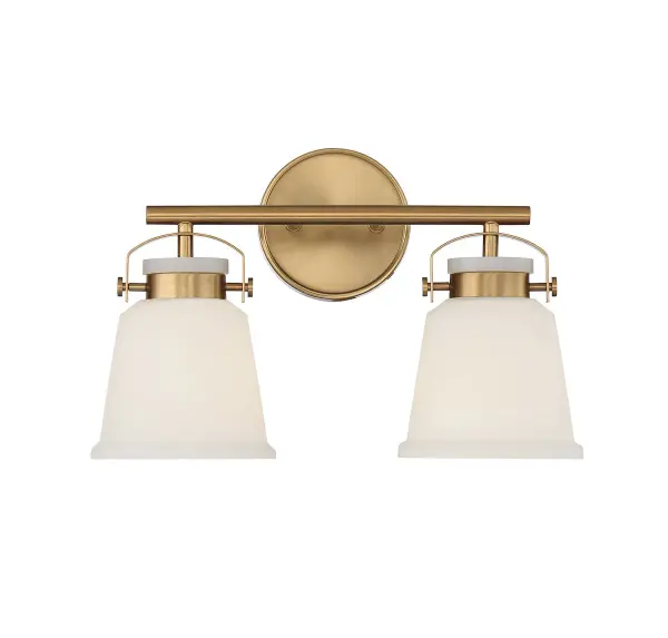 The Kaden 2-light vanity combines timeless design with industrial-inspired hardware in a warm brass finish. White opal glass shades provide soft, even illumination perfect for bathroom tasks. Compact 16-inch width fits most vanity spaces.