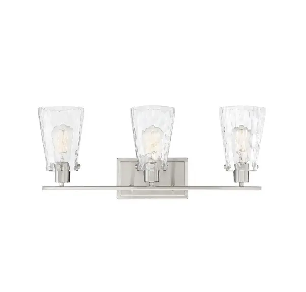 The Vaughan bath bar combines sleek design with functional lighting through its distinctive fluted clear water glass shades and satin nickel finish. Perfect for modern bathrooms seeking a fresh, elegant aesthetic.