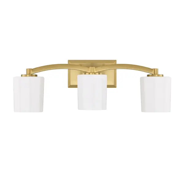 The Whitney 3-light vanity combines understated glamour with practical functionality. Fluted opal etched glass shades provide soft, flattering illumination perfect for grooming tasks, while the warm brass finish adds timeless elegance. - alternate view