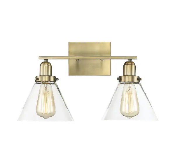 The Drake bath bar combines minimalist design with industrial hardware details and clear glass shades. Its warm brass finish adds sophistication while the exposed bulb design allows for creative styling with Edison bulbs.