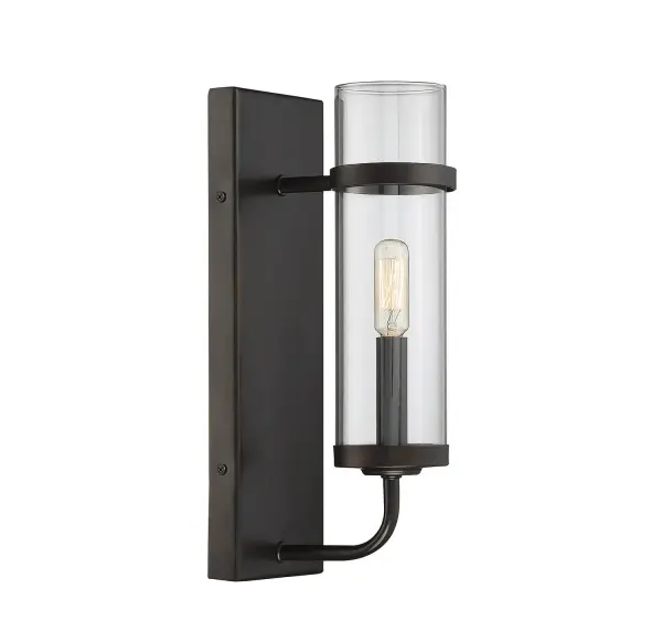 The Tulsa wall sconce delivers understated industrial style with its clean lines, dark English bronze finish, and clear glass shade. Perfect for adding vintage character to any room while providing focused ambient lighting.