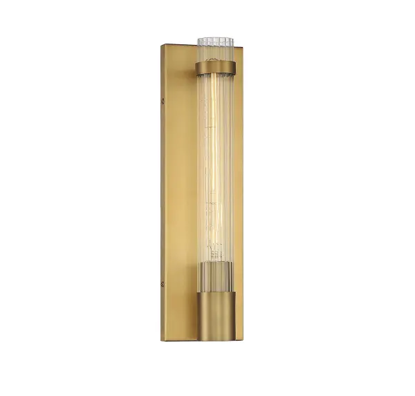 The Willmar wall sconce combines classic elegance with contemporary simplicity. Its warm brass finish and distinctive reeded glass create sophisticated ambient lighting perfect for hallways, bathrooms, and entryways.