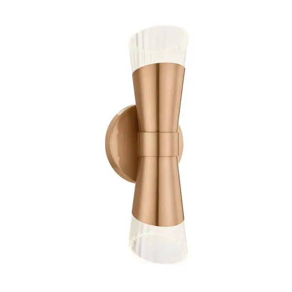 Sculptural 2-light wall sconce offers a bold yet refined presence with a balanced, symmetrical silhouette, From the center, the body flares upward and downward in mirrored fashion, creating an elegant hourglass-like silhouette, Can be mounted vertically or horizontally for flexible design and layout options, Brushed brass finish adds warmth and a sophisticated accent that elevates both modern and transitional interiors, Tapered clear ribbed glass shades feature an angled cut, creating dynamic visual interest and an architectural profile when viewed from the side, Ribbed glass softly diffuses light while adding texture and depth, enhancing the fixture's appearance both on and off, Integrated LED technology delivers energy-efficient, long-lasting illumination with a clean, seamless look, 3000K warm white light provides an inviting glow suitable for residential, commercial, and hospitality spaces, Dimmable capability allows precise control of light levels to suit different moods and applications, ADA-compliant profile makes it ideal for corridors, bathrooms, bedrooms, and other narrow spaces, Damp-location rated for versatility in bathrooms and covered outdoor or hospitality settings, Minimal hardware visibility keeps the focus on the refined form and material interplay, Timeless and versatile aesthetic pairs effortlessly with today's furnishings, from contemporary to elevated classic interiors. Collection: Fusion Finish: Brushed Brass Glass: Ribbed Glass Width: 4.75" Height: 13.00" Extension from Wall: 4.00" Canopy: 4.75" Dia x 0.75" Proj. Number of Bulbs: 2 Maximum Wattage: 4.50 W Light Source: LED Light Output: 810.00 lm Delivered Lumens: 325.00 lm Voltage: 120.00 V Safety Rating: Damp ADA LED