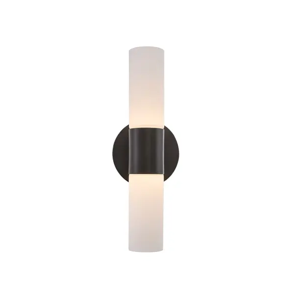 Sleek, architectural two-light wall sconce with a refined vertical presence, Dual cylindrical opal glass shades deliver illumination both upward and downward for balanced, layered light, Opal glass is smooth on the exterior with subtle fluted detailing on the interior, revealed softly when illuminated for added depth and texture, Matte Black metal finish creates crisp contrast against the luminous glass for a modern, tailored look, Refined metal center column anchors the design and creates a clean, symmetrical composition, Minimal round backplate keeps the installation visually light and architecturally precise, Glass shades install easily by hand with a simple screw-on / screw-off design for straightforward installation and maintenance, ADA compliant with less than 4" projection from the wall to the outer edge of the glass, Suitable for corridors, hallways, and high-traffic areas without compromising accessibility or design, Can be installed vertically or horizontally to suit different layouts and design intent, Up-and-down light distribution enhances wall texture, architectural detail, and spatial depth, Creates visual interest both illuminated and unlit through proportion, material contrast, and light diffusion, Provides ambient, decorative lighting without visual clutter, Modern design with subtle mid-century influence for long-term style longevity, Ideal for hallways, stairways, bedrooms, bathrooms, and living spaces, Perfect for flanking mirrors, highlighting artwork, or accenting architectural features, Integrated LED light source delivers efficient, consistent illumination, 3000K warm color temperature creates a comfortable, inviting glow, Dimmable for adjustable ambiance and lighting control, Rated for damp locations, making it suitable for bathroom and vanity environments, Versatile, timeless design appropriate for residential, hospitality, multifamily, and commercial applications. Collection: Fusion Finish: Matte Black Glass: Ribbed Glass Width: 4.50" Height: 13.50" Extension from Wall: 4.00" Canopy: 4.5" Dia x 1" Proj. Number of Bulbs: 2 Maximum Wattage: 4.50 W Light Source: LED Light Output: 810.00 lm Delivered Lumens: 530.00 lm Voltage: 120.00 V Safety Rating: Damp ADA LED