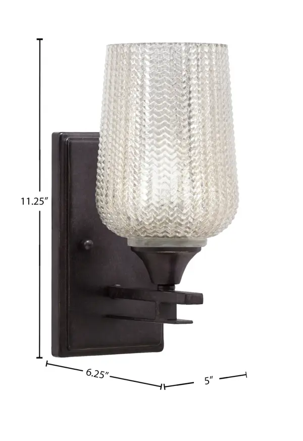 The Uptowne Wall Sconce combines a sophisticated dark granite finish with distinctive silver textured glass, creating visual interest in any space. Its compact 5-inch width and up-or-down mounting flexibility make it ideal for hallways, bedrooms, and bathrooms where space-efficient lighting is essential. - alternate view