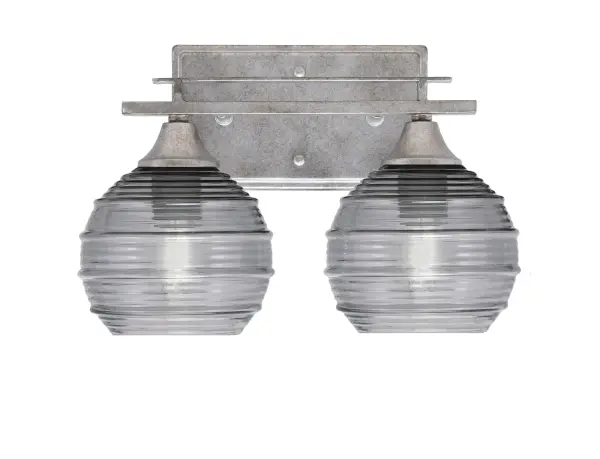 The Uptowne 2-Light Bath Bar combines timeless aged silver finish with unique smoke ribbed glass shades, delivering soft ambient lighting perfect for bathrooms. Versatile mounting options and dimmable capability make it adaptable to various spaces.