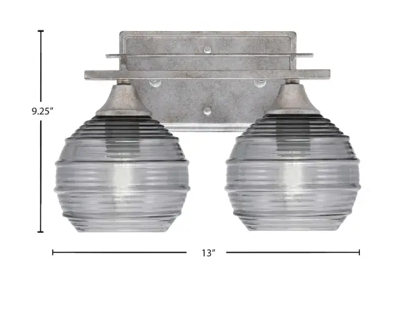 The Uptowne 2-Light Bath Bar combines timeless aged silver finish with unique smoke ribbed glass shades, delivering soft ambient lighting perfect for bathrooms. Versatile mounting options and dimmable capability make it adaptable to various spaces. - alternate view