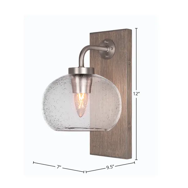 The Oxbridge Wall Sconce combines distressed wood-look metal with clear bubble glass for a warm, inviting glow. Its compact 7-inch width and up-or-down mounting flexibility make it perfect for hallways, bathrooms, and entryways. - alternate view