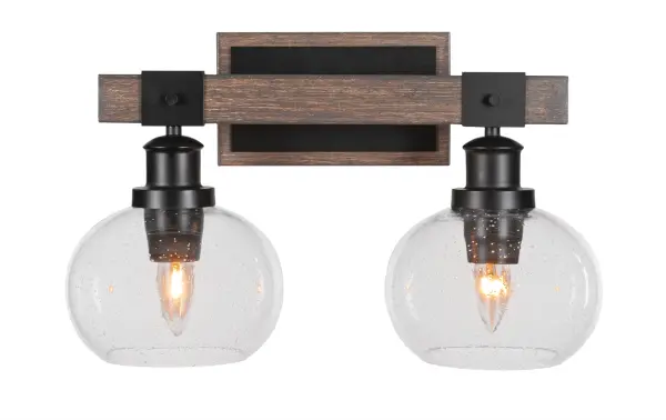 The Tacoma 2-Light Bath Bar combines matte black metal with painted distressed wood-look accents and clear bubble glass shades for a unique industrial-farmhouse aesthetic. Versatile mounting options and dimmable capability make it adaptable.