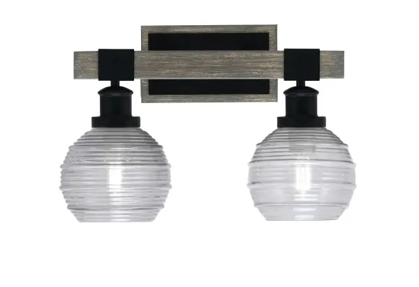 The Tacoma 2-Light Bath Bar blends industrial style with rustic farmhouse charm through its matte black finish and distressed wood-look metal accents. Smoke ribbed glass shades provide warm, diffused lighting perfect for bathroom vanities.
