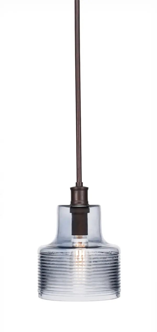 The Aurora Pendant combines a striking 7.5" blue glass shade with a bronze finish for a contemporary look that works in various settings. Compact size and adjustable height make it versatile for smaller spaces.