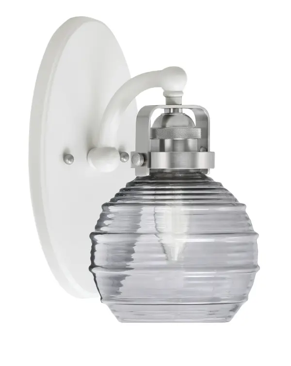 The Easton Wall Sconce combines a striking white and brushed nickel finish with a unique smoke ribbed glass shade that diffuses light beautifully. Its compact 6-inch width and versatile up/down mounting make it perfect for hallways, bedrooms, and bathrooms.
