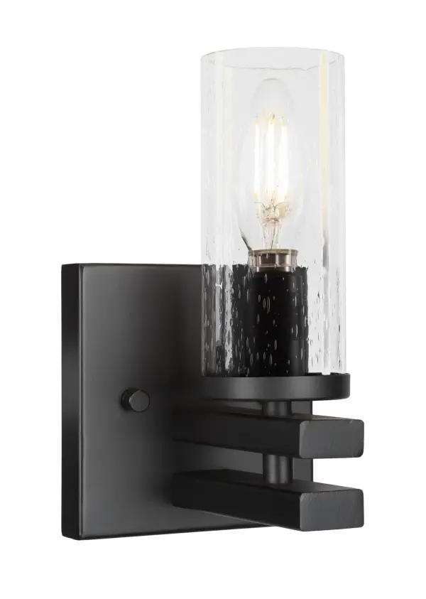 The Belmont Wall Sconce combines modern matte black styling with unique clear bubble glass for a sophisticated look. Its compact 8.25" height makes it ideal for smaller spaces while the upward light direction creates ambient illumination.