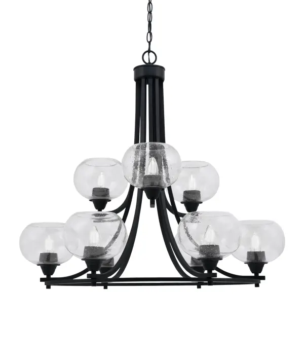 The Paramount chandelier combines contemporary matte black finish with unique clear bubble glass shades for a striking visual impact. Nine upward-facing lights create ambient illumination perfect for dining and living spaces.