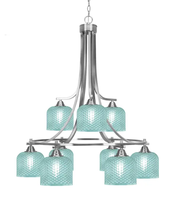 The Paramount 9-Light Chandelier combines sleek brushed nickel with striking turquoise textured glass shades, creating a sophisticated focal point. Its generous 29.5-inch width and adjustable height make it versatile for various ceiling heights.