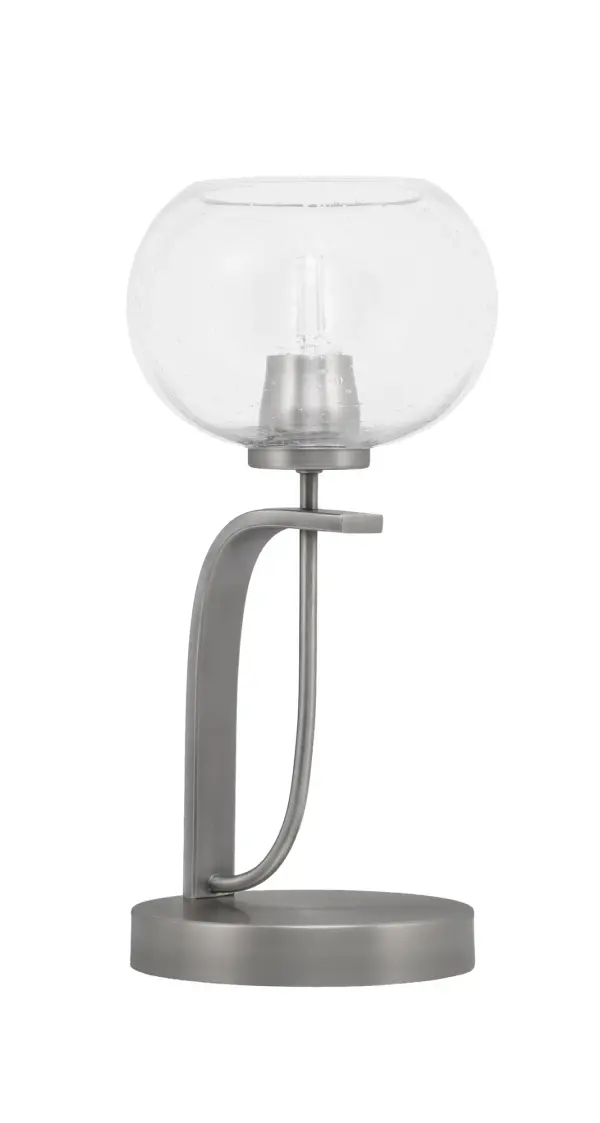 The Cavella Accent Lamp combines contemporary design with industrial charm through its graphite finish and unique 7-inch clear bubble glass shade. At 15.25 inches tall, it provides ambient lighting perfect for nightstands and accent tables.