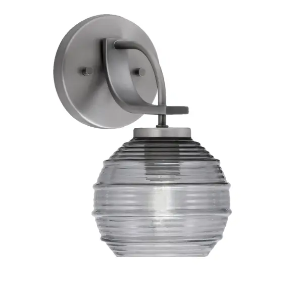 The Cavella Wall Sconce combines industrial charm with transitional elegance. Its compact 6-inch smoke ribbed glass shade and graphite finish make it ideal for bathrooms, hallways, and accent lighting.