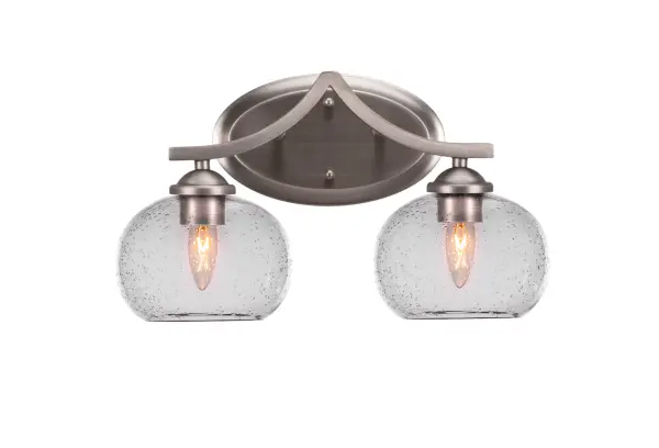 The Zilo 2-Light Bath Bar combines contemporary style with practical functionality. Its graphite finish and clear bubble glass create visual interest while providing excellent task lighting for bathrooms.