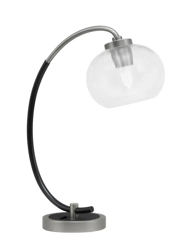 This versatile desk lamp combines industrial style with modern elegance through its graphite and matte black finish. The 7" clear bubble glass shade creates textured light diffusion while the compact 15.5" width fits most workspaces.