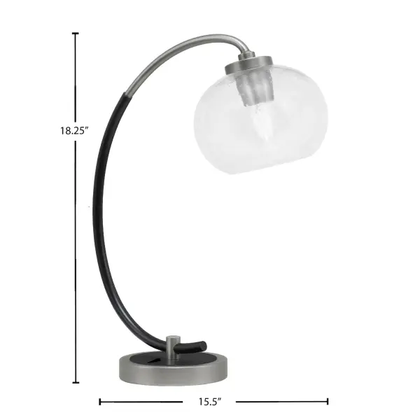 This versatile desk lamp combines industrial style with modern elegance through its graphite and matte black finish. The 7" clear bubble glass shade creates textured light diffusion while the compact 15.5" width fits most workspaces. - alternate view