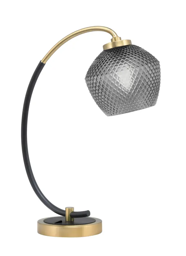 This stylish desk lamp combines matte black and new age brass finishes with a unique smoke textured glass shade. Perfect for home offices and workspaces, it provides focused task lighting with modern industrial flair.