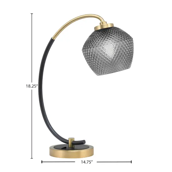 This stylish desk lamp combines matte black and new age brass finishes with a unique smoke textured glass shade. Perfect for home offices and workspaces, it provides focused task lighting with modern industrial flair. - alternate view