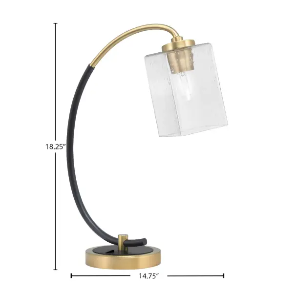 This contemporary desk lamp combines a sleek matte black base with new age brass accents and a unique 4-inch square bubble glass shade. The textured glass diffuses light beautifully while the dual-finish design adds visual interest to any workspace or bedroom. - alternate view