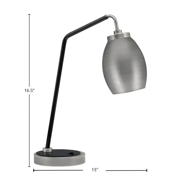 This stylish desk lamp combines graphite and matte black finishes with a unique oval metal shade for focused task lighting. Compact 15" width fits any desk while providing ambient glow for work or study sessions. - alternate view