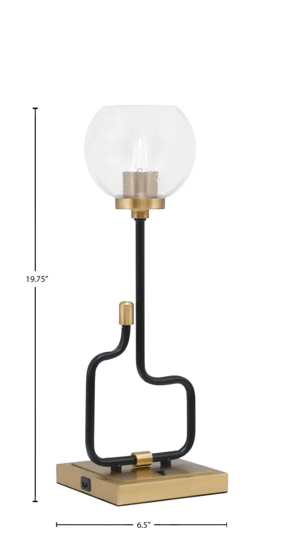 The Sandia Accent Lamp combines contemporary design with practical functionality. Featuring a striking matte black and aged brass finish with a unique 5.75" clear bubble glass shade, this compact lamp includes built-in USB ports for charging devices. Perfect for modern bedrooms, home offices, or living spaces where style meets convenience. - alternate view