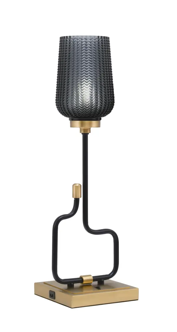 The Sandia Accent Lamp combines contemporary style with practical functionality. Featuring a sophisticated matte black and aged brass finish with smoke textured glass, it includes built-in USB ports for device charging.