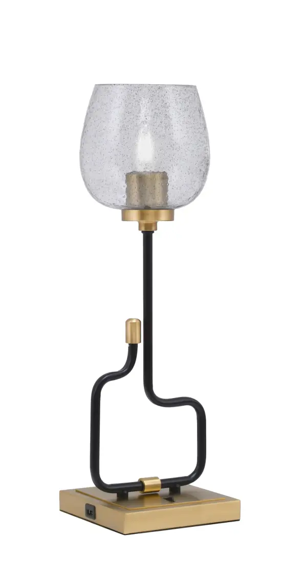 The Sandia Accent Lamp combines contemporary style with everyday functionality. Its two-tone matte black and aged brass finish paired with textured smoke bubble glass creates visual interest, while built-in USB ports add modern convenience for bedside or desk use.