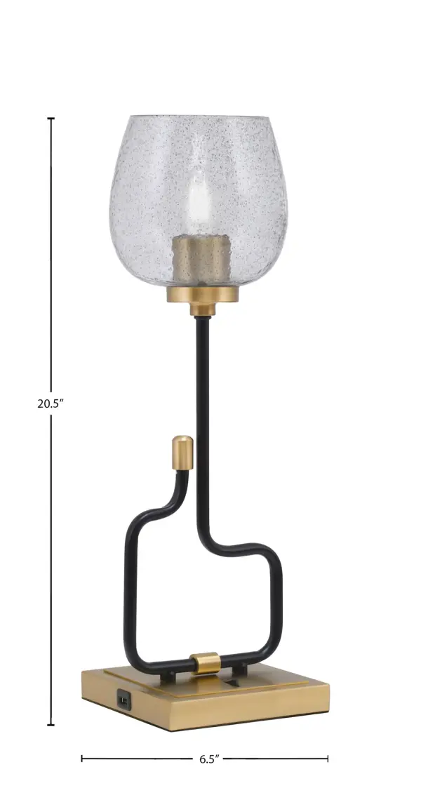 The Sandia Accent Lamp combines contemporary style with everyday functionality. Its two-tone matte black and aged brass finish paired with textured smoke bubble glass creates visual interest, while built-in USB ports add modern convenience for bedside or desk use. - alternate view