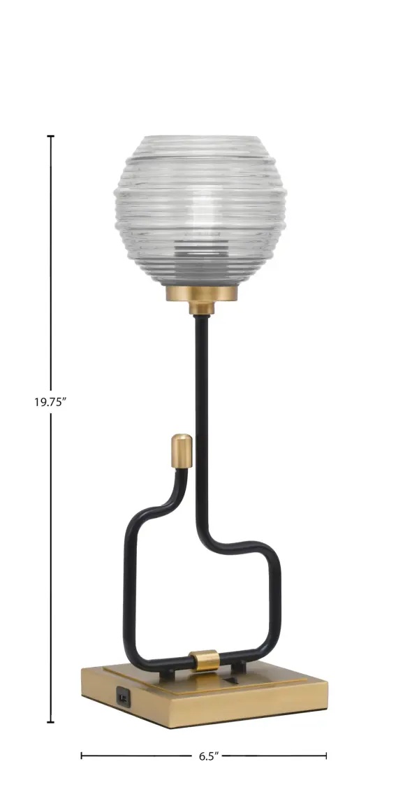 The Sandia Accent Lamp combines contemporary style with practical functionality. Featuring a striking matte black and aged brass finish with textured ribbed glass, this compact lamp includes built-in USB ports for device charging—perfect for modern living spaces. - alternate view