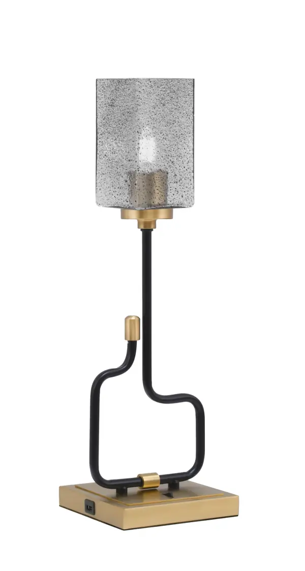 The Sandia Accent Lamp combines contemporary style with practical functionality. Its matte black and aged brass finish creates visual interest, while the smoke bubble glass shade adds texture and warmth. Built-in USB ports make it perfect for modern living.