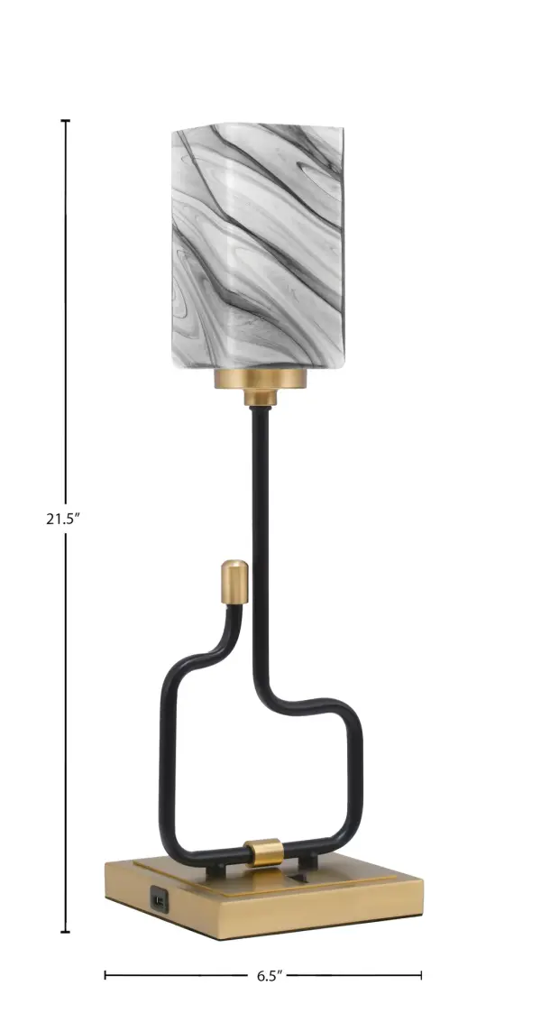 The Sandia Accent Lamp combines contemporary style with practical functionality. Featuring a striking matte black and aged brass finish with unique onyx swirl glass shade, this compact lamp includes built-in USB ports for device charging. - alternate view